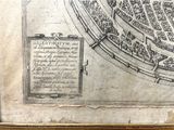 an old map of a city in a frame on a table