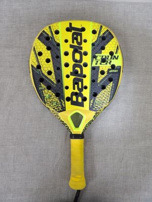 a yellow and black racquet with black dots on it