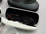 a pair of glasses, a pair of ear buds, a pair of sunglasses, and a pair of ear buds in a case