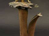 bronze figurine of a lion on top of a tree stump
