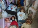 a lot of dolls that are sitting on the floor