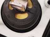 a close up of a metal plate with a button on it
