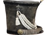 a black hat with a rope and a white tassel on it