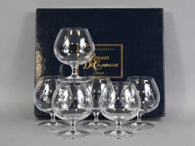 four empty wine glasses are sitting in front of a box