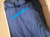 a blue jacket in a cardboard box on the floor