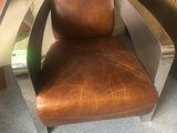 brown leather office chair with chrome frame and arm rest