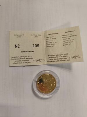 a gold coin on a white table with a receipt