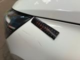 a sticker on the hood of a white car