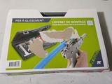 someone is holding a gun with a piece of cardboard on top of it