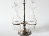 three glass vases sitting on top of a metal stand