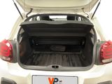 the back of a white car with the trunk open and luggage in the trunk
