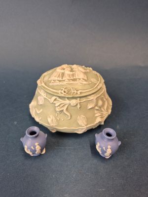two small vases sitting next to each other on a table
