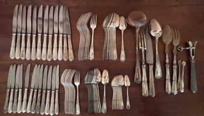 a lot of silverware on a wooden table