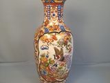 un vase avec un oiseau posé sur une table