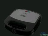 a close up of a sandwich maker on a black background