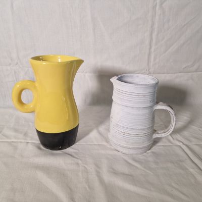 two vases sitting next to each other on a table