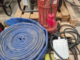 a red fire hydrant sitting on a pallet next to a blue hose