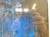 a man that is taking a picture of himself in the mirror