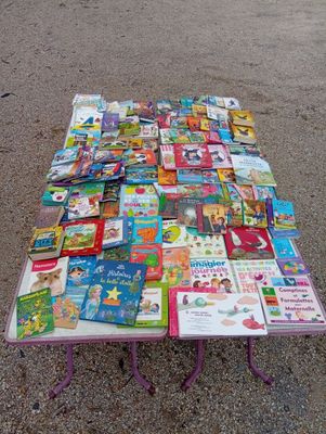 a table with many books on it on the ground