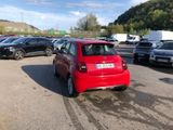 a red car that is parked in a parking lot