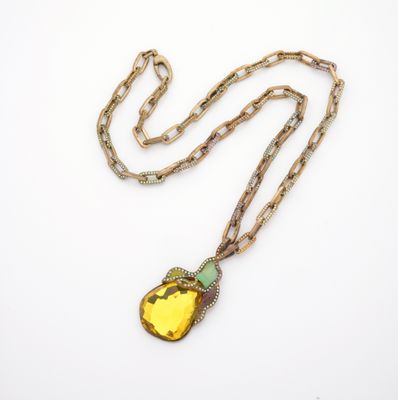 a gold necklace with a yellow stone pendant on a chain