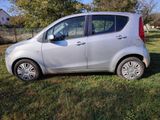 a picture of a small silver car parked in the grass