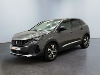 a grey car is parked in a room with a white wall