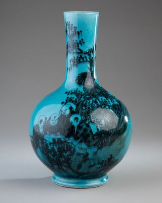 a blue glass vase with a picture of a castle on it