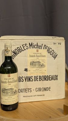 a bottle of wine sitting on a table next to a box of wine
