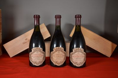 three bottles of wine sitting on a table next to a wooden box