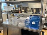 a large kitchen with a lot of pots and pans on the counter