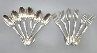 six silver plated forks and spoons on a gray surface
