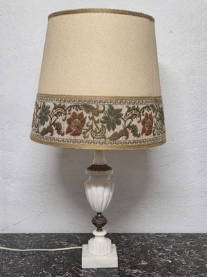 a lamp that is sitting on a table next to a wall