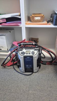a radio that is sitting on the floor in front of a bookcase