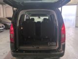 the back of a black van with its doors open in a garage