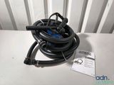 a close up of a hose on a table with a tag on it