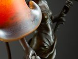 a statue of a woman holding a vase on a table