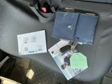 a black bag with a passport and some papers on it