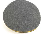 a close up of a grey and yellow disc on a white surface