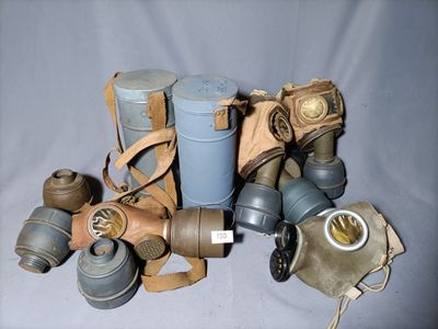 many gas masks that are sitting on a table