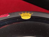a close up of a crown emblem on the rim of a car