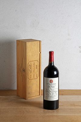 a bottle of wine sitting next to a box on a table