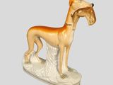 figurine of a dog with a collar on a white base