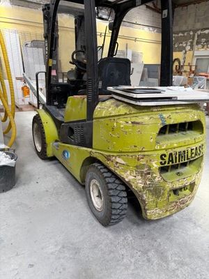 a yellow fork truck parked inside of a building