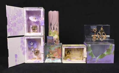 four boxes with different items in them on a black background