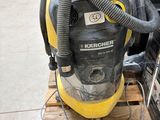 a yellow and black vacuum sitting on a pallet in a warehouse
