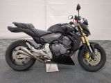 a picture of a black motorcycle parked in a garage