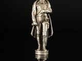 une figurine en argent représentant un homme en uniforme militaire