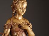 a statue of a woman holding a basket of flowers