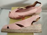 a pair of pink shoes sitting on top of a box